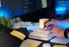 A developer taking notes on a laptop, representing personal knowledge management tools