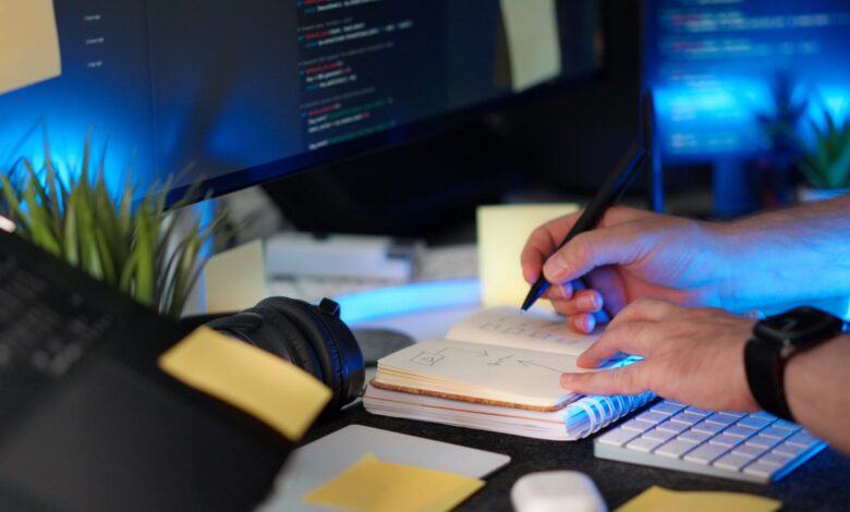 A developer taking notes on a laptop, representing personal knowledge management tools
