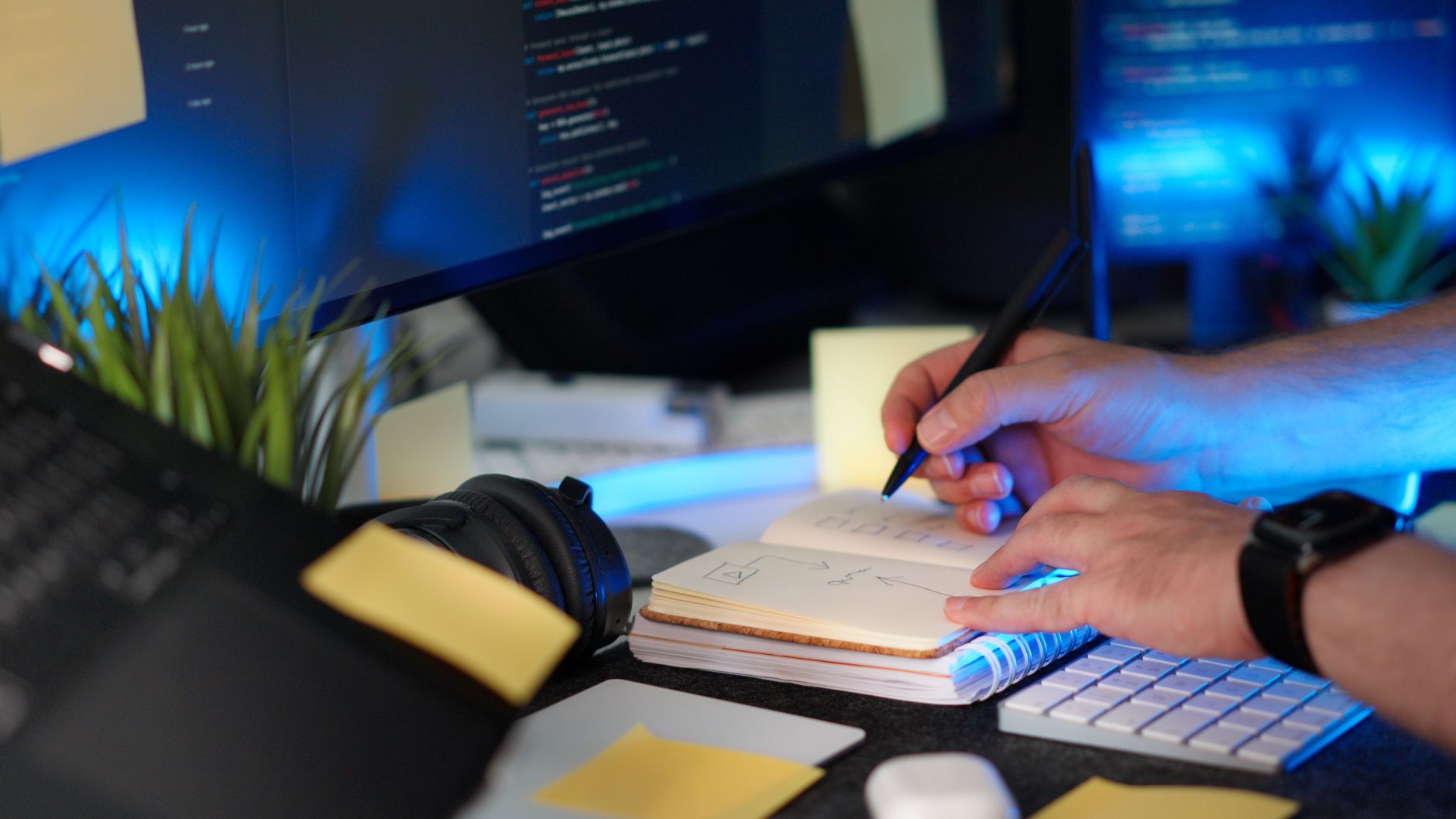 A developer taking notes on a laptop, representing personal knowledge management tools