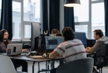 Modern office workspace with computer screens showing digital productivity tools