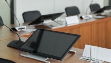Empty corporate boardroom with large windows and conference table representing executive decision-making
