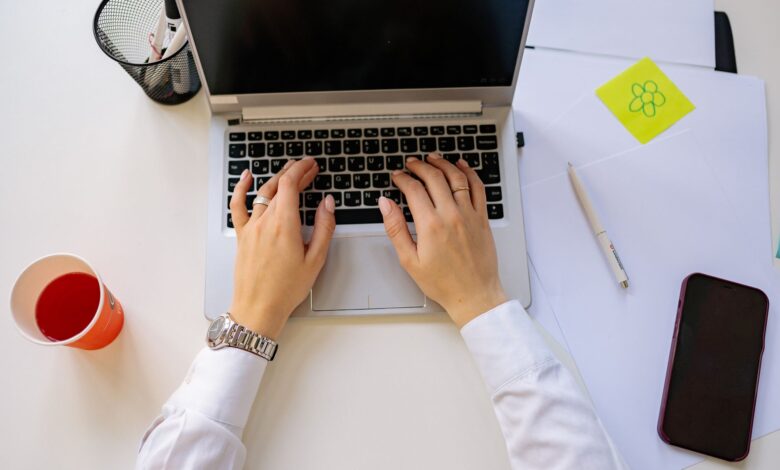 Person working on laptop setting up automated workflows across multiple applications