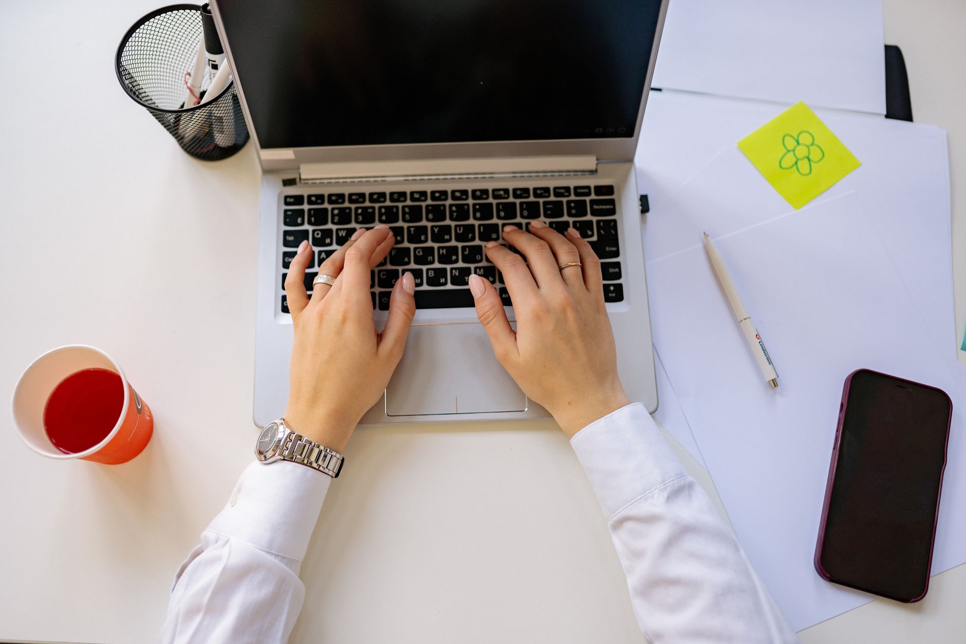 Person working on laptop setting up automated workflows across multiple applications