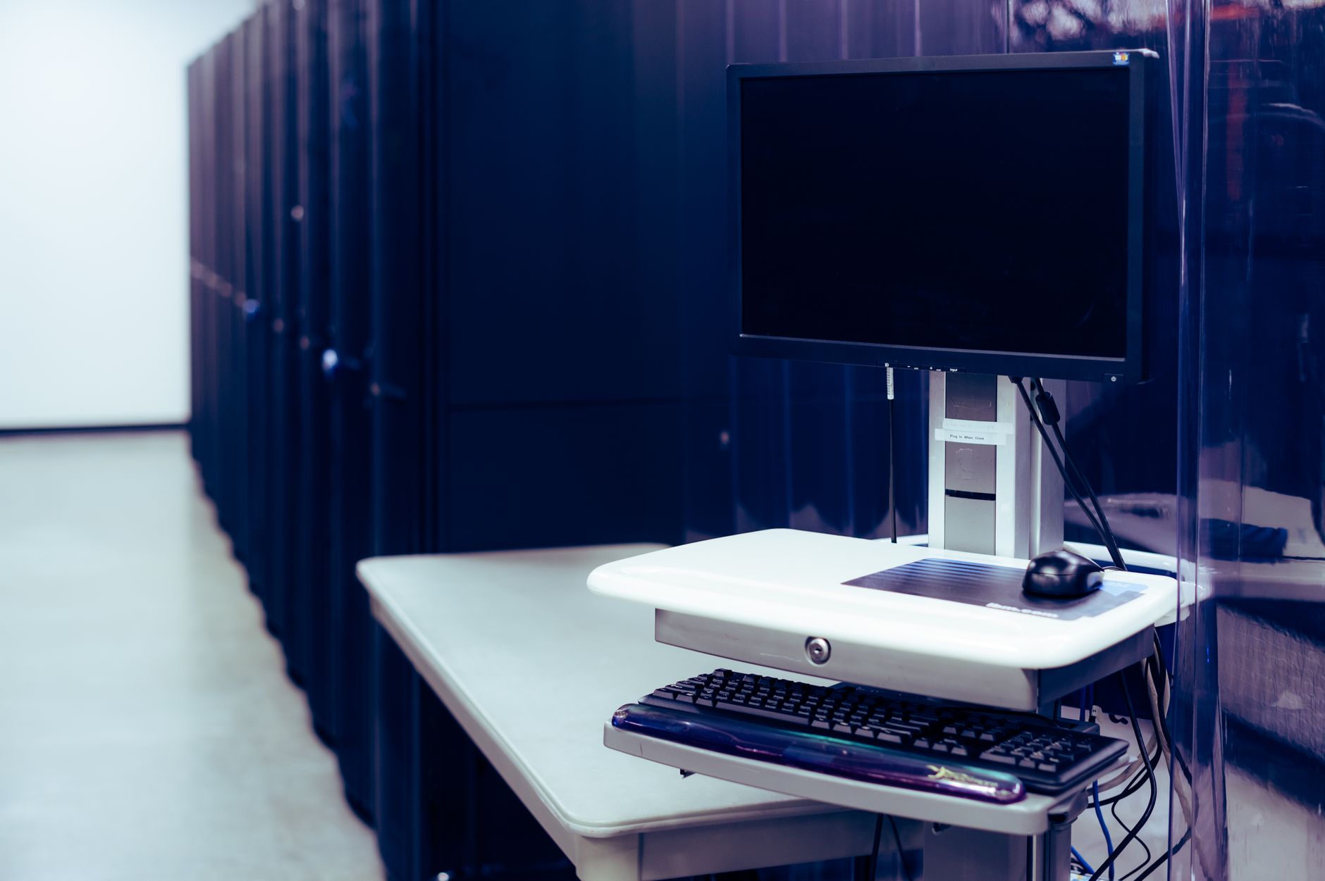 Rows of illuminated servers in a modern data center representing cloud computing infrastructure
