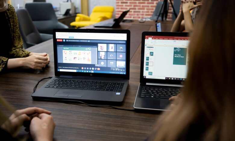 Designer working on a UI layout on a laptop screen in a modern workspace