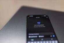 Person holding a smartphone while using a voice assistant feature