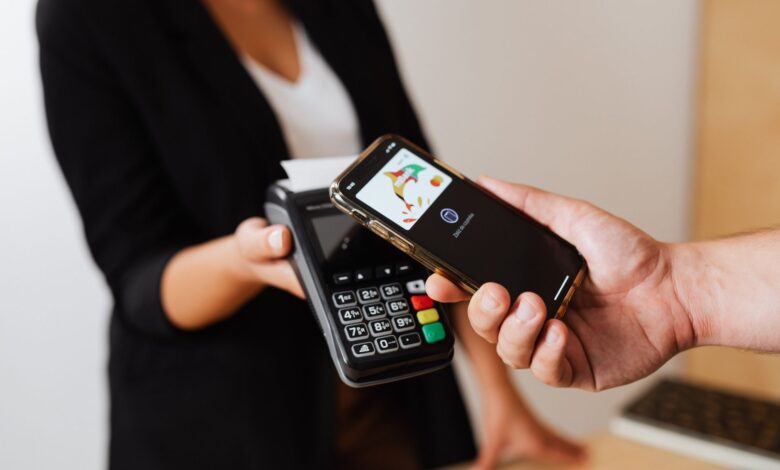 Person using smartphone to complete a mobile payment at checkout