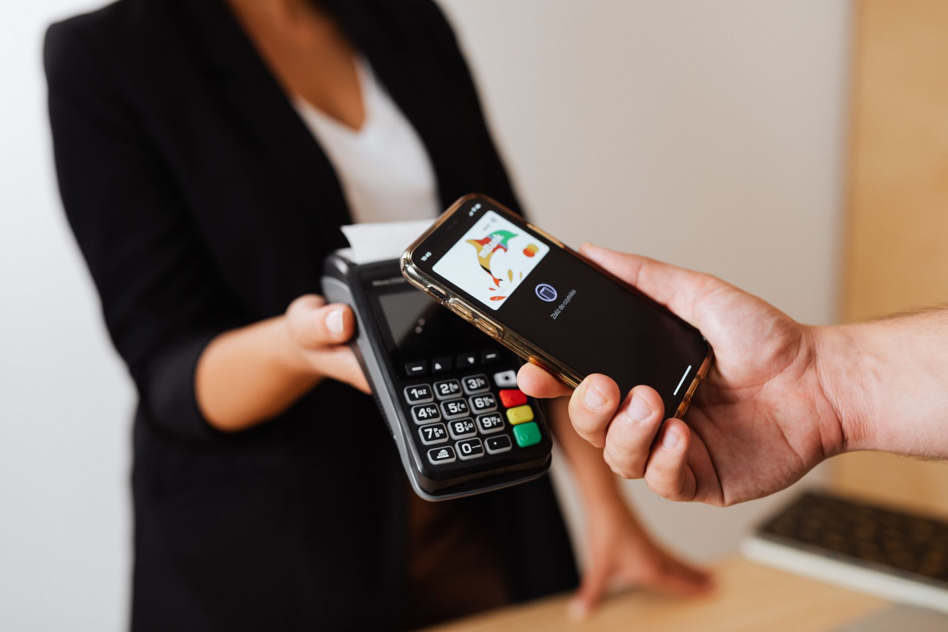 Person using smartphone to complete a mobile payment at checkout