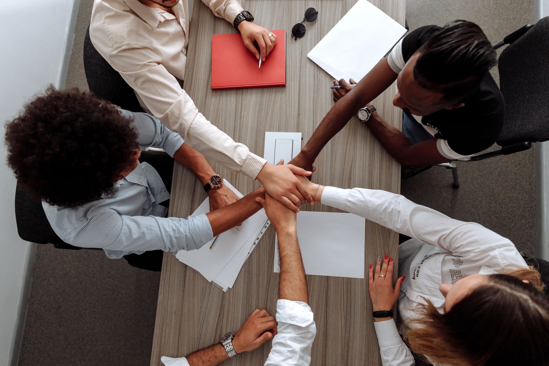 Team members collaborating around a table in a modern office environment