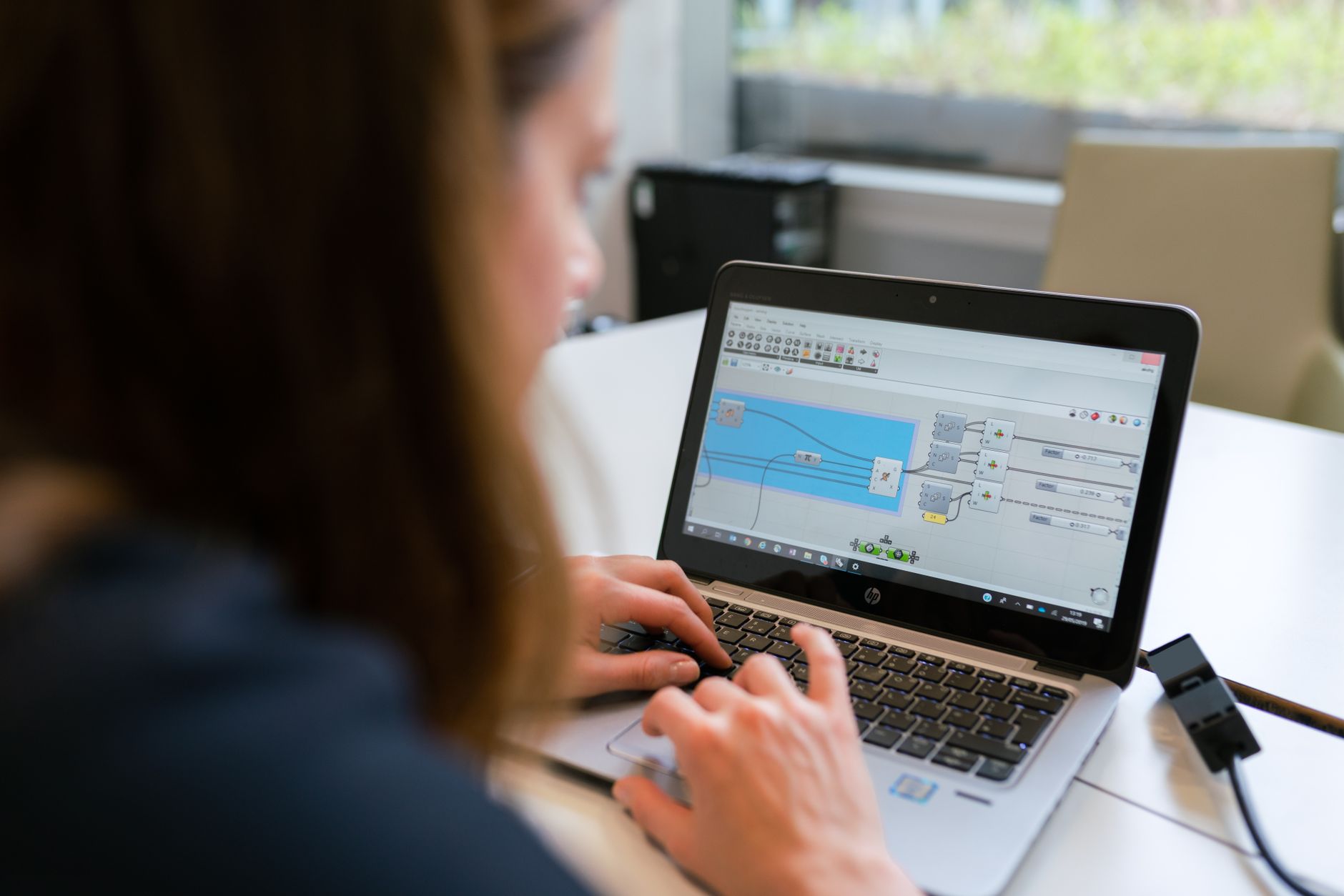 Employee using HR platform software on a laptop in a modern office setting
