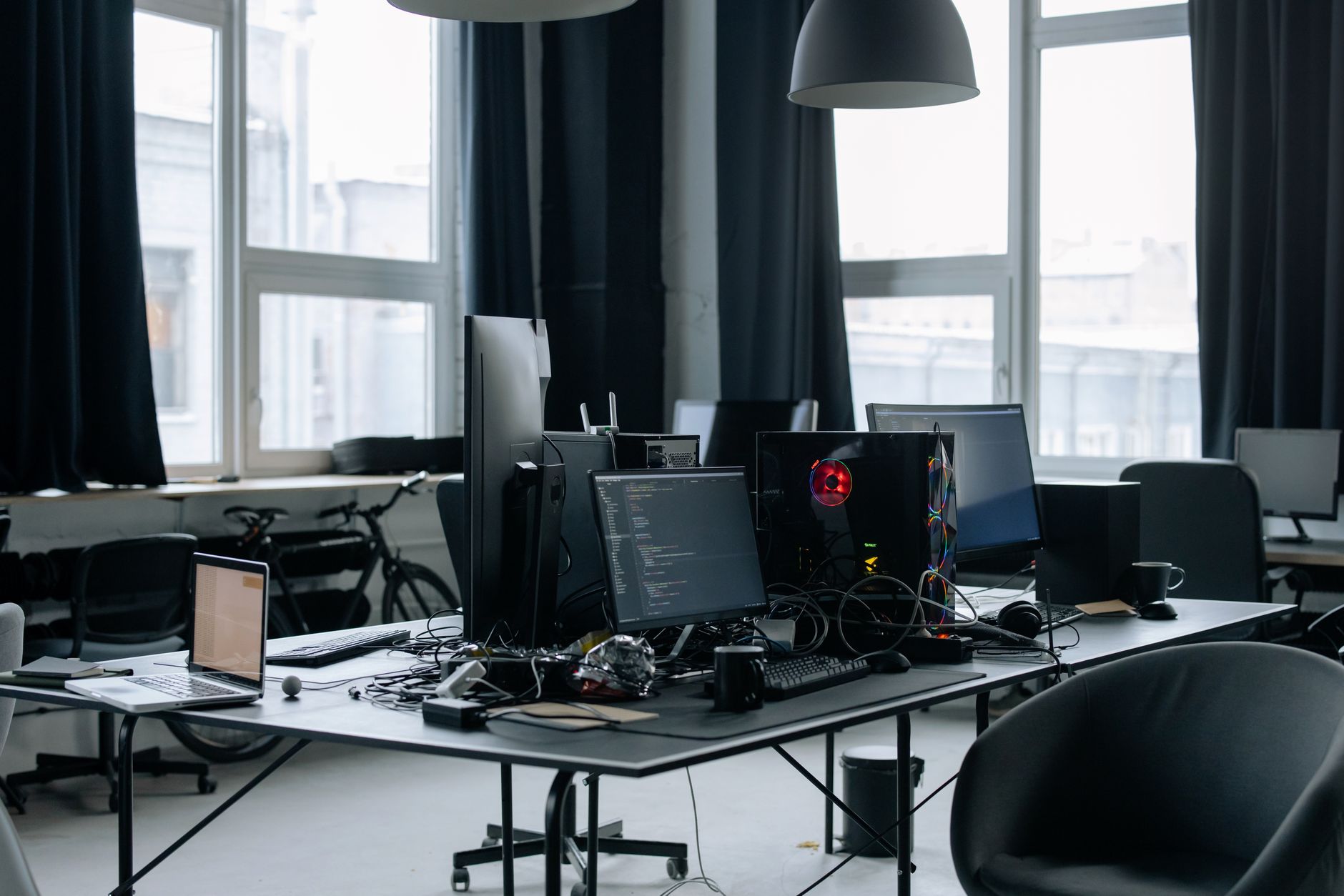 Software developer reviewing code at a desktop workstation