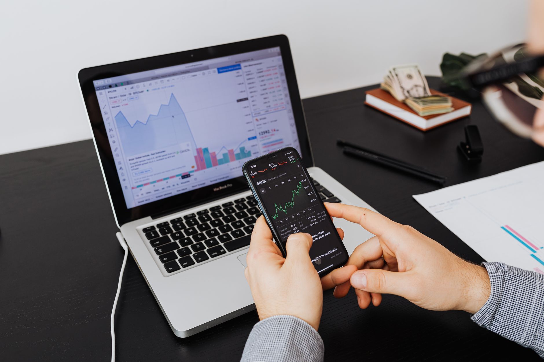 Young investor monitoring stock and crypto markets on a mobile device