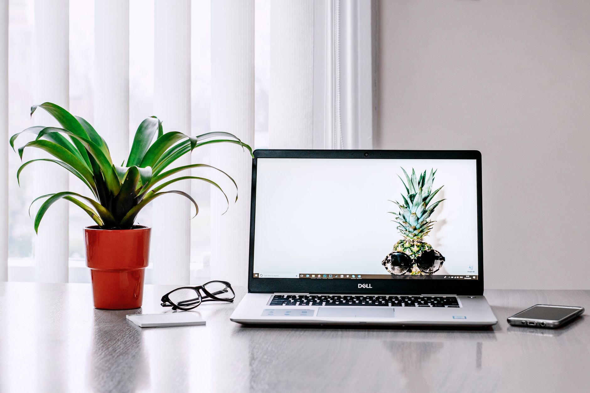 A designer working on a visual project on a laptop in a clean workspace