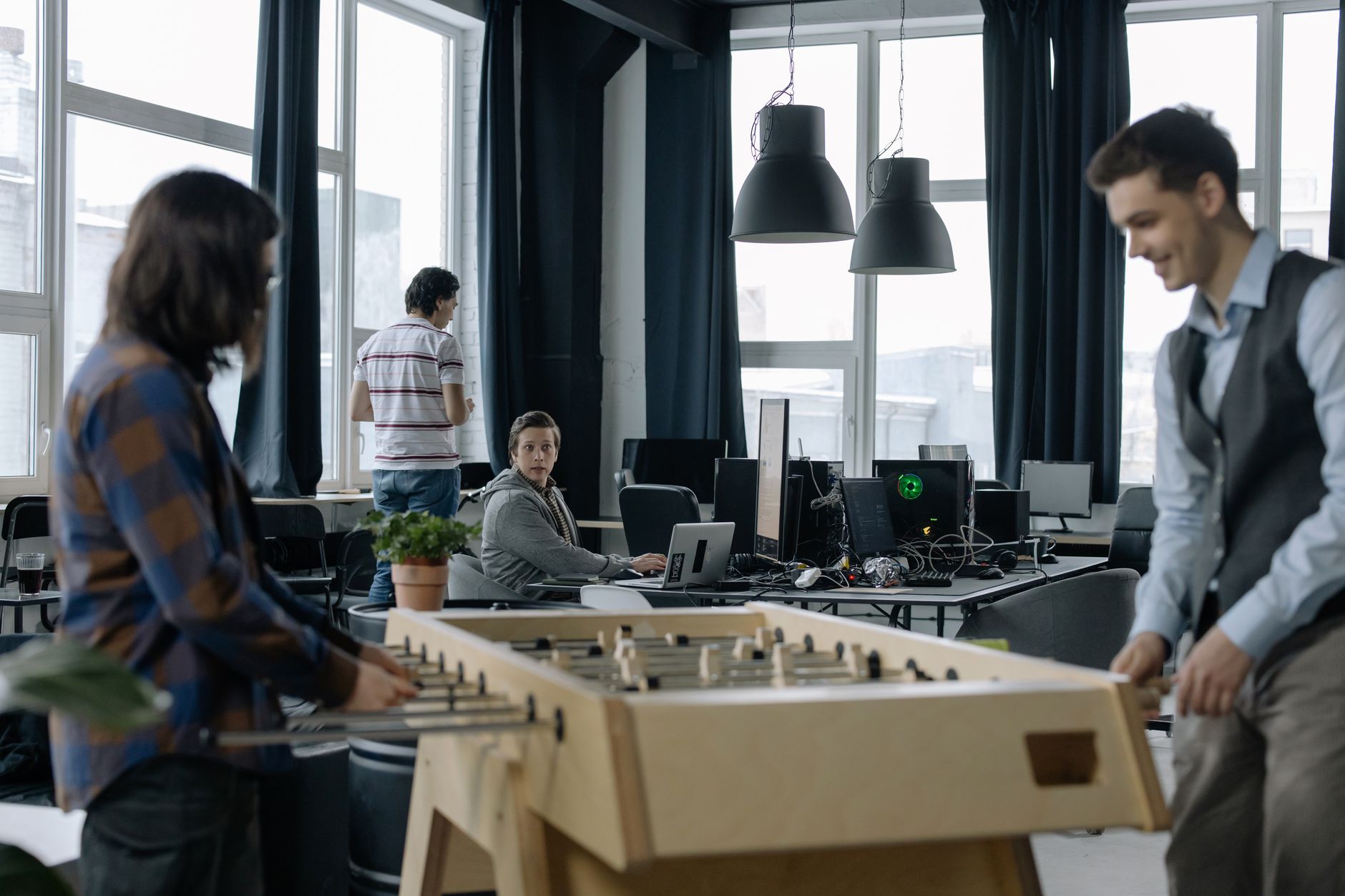 Open-plan technology startup office with screens and collaborative workspace