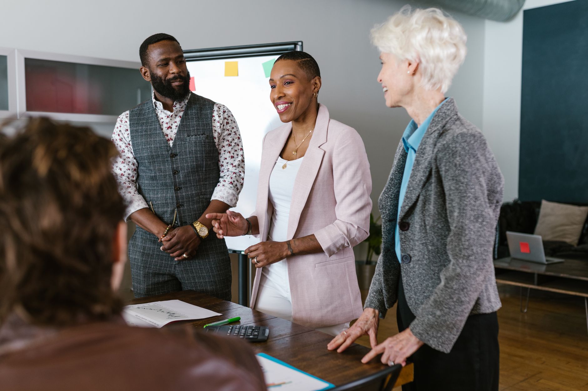Business professionals in a meeting room discussing investment strategy and portfolio returns