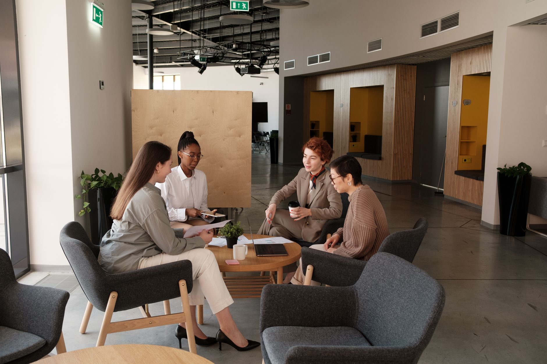HR professionals reviewing workforce data on screens in a conference room
