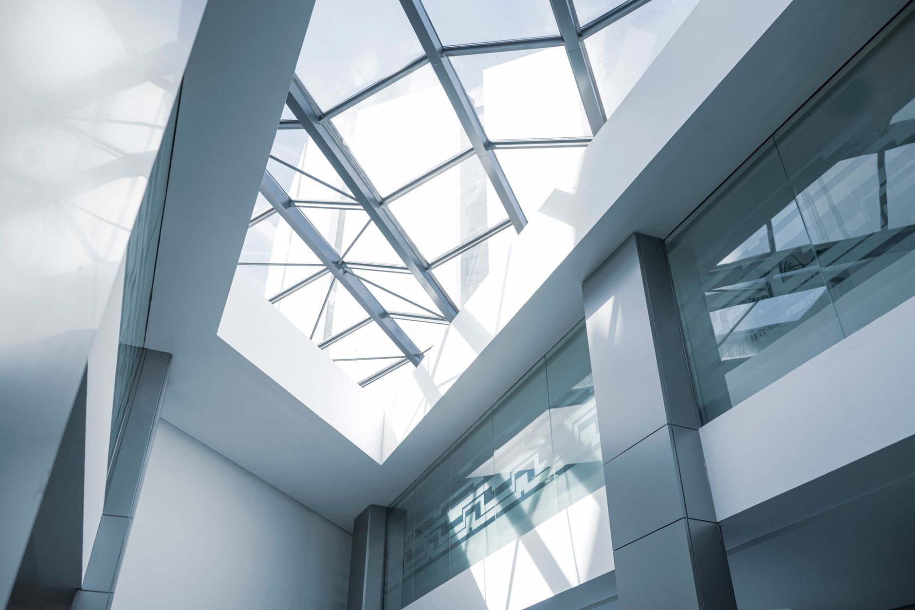 Modern open-plan technology office space with workstations and screens