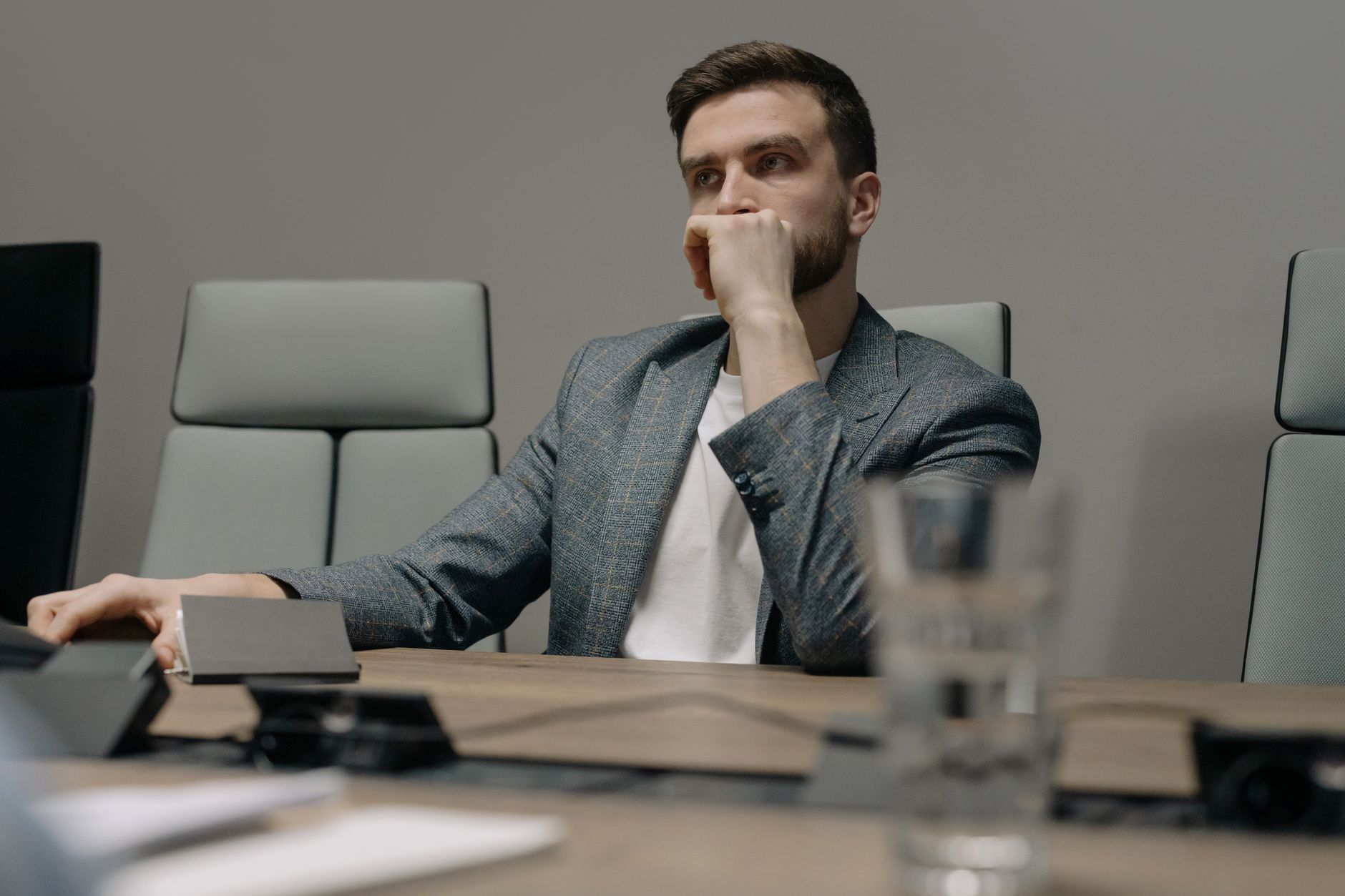 Corporate executives reviewing technology procurement options in a boardroom meeting
