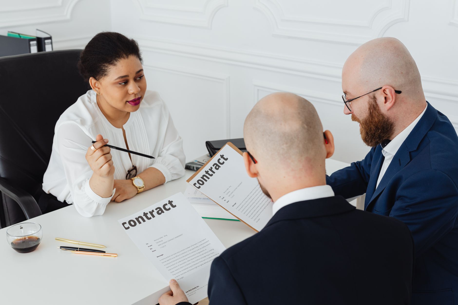 Business professionals reviewing enterprise technology contracts in a conference room