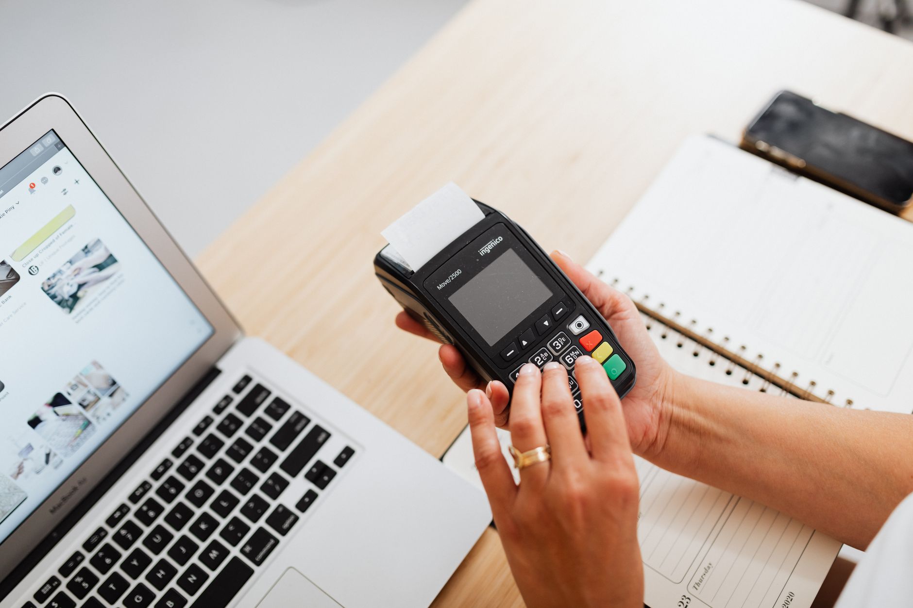A merchant reviewing payment processing options on a laptop