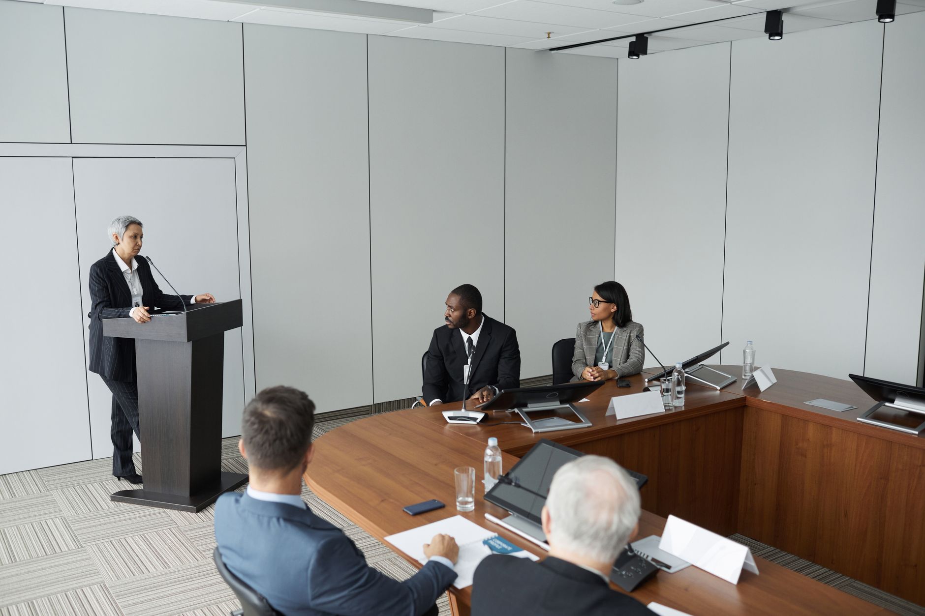 Empty corporate boardroom with chairs arranged around a large executive table